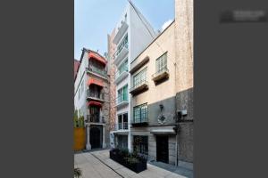 a group of buildings on a city street at Duplex Penthouse Zona Rosa in Mexico City