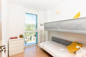 a bedroom with a bunk bed and a window at Villa Senia, close to Sitges with private pool in Olivella +24 photos