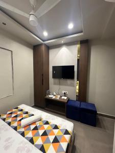 a bedroom with a bed and a desk and a tv at HOTEL PREMIER CHOICE - JUST 50 Meters FROM AJMER SHARIF DARGAH in Ajmer