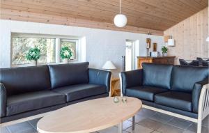 a living room with couches and a table at Holiday Home Musvãgevej Ã Lbãk X in Ålbæk