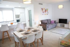a kitchen and living room with a table and chairs at Villa Blanca with private pool - San Javier in San Javier