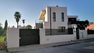 a white house with a gate and a fence at Villa Blanca with private pool - San Javier in San Javier