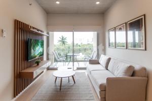 a living room with a couch and a table at Modern 2 Bedroom Apartment Near Paseo La Galeria in Asuncion