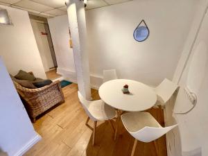 a white table and chairs in a room at Dotan's Boutique Guesthouse - By The Beach! in Tel Aviv