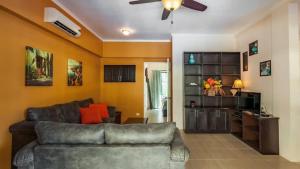 a living room with a couch and a ceiling fan at 2-Bedroom, 2-Bath Condo Near Beach in Coco