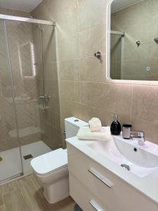 a bathroom with a toilet and a sink and a shower at El Paraiso in Gran Tarajal