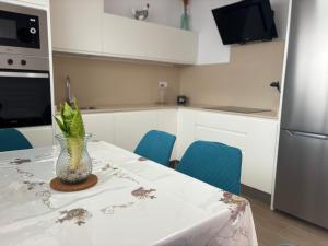 a kitchen with a table with a vase on it at El Paraiso in Gran Tarajal