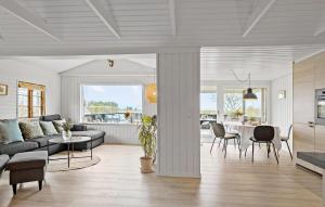 a living room with a couch and a table at Holiday Home Hejsager Strandby Haderslev Iv in Kelstrup Strand