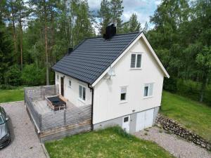 a small white house with a roof on a yard at Nordic Haven in Vansbro