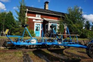 a blue bike on the tracks in front of a house at Nordic Haven in Vansbro