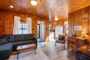 a living room with a couch and a kitchen at Loon Lodge in Holderness