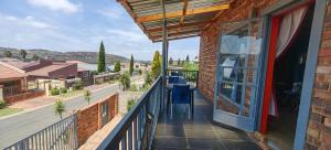 a balcony with a view of a city at St Michael & The Queen in Johannesburg