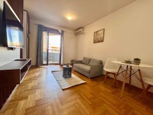 a living room with a couch and a table at Apartment Milana in Konik
