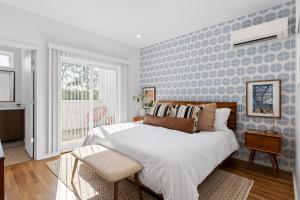 a bedroom with a large bed with a blue accent wall at South Side Modern - Downtown Living - Amazing Location in Chattanooga