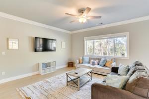 a living room with a couch and a ceiling fan at 5 Mi to Shasta Lake Newly Built Home with Backyard! in Shasta Lake