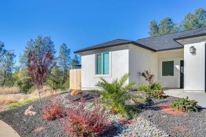 a house with a garden in front of it at 5 Mi to Shasta Lake Newly Built Home with Backyard! in Shasta Lake
