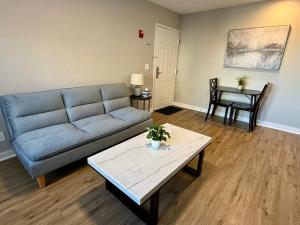 a living room with a couch and a table at Aksarben View One Bedroom in Omaha