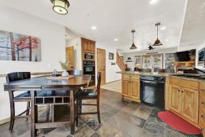 a kitchen with a wooden table and a dining room at Eden Escape most desirable floor plans in all of Moose Hollow Luxury Condos in Eden