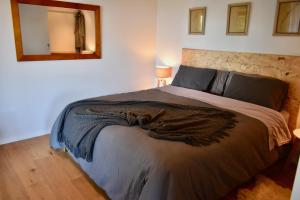 a bedroom with a large bed with a mirror on the wall at The Heights in Russell