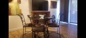 two chairs and a table in a room with a television at Huge 1 Bedroom in Heart of Kihei in Kihei