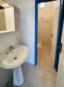 a bathroom with a white sink and a shower at Terrazza Vitaloca in Scopello