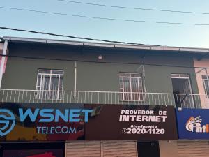 a building with a sign in front of it at Apto Grande Vitória in Manaus