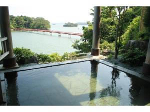 a swimming pool with a view of a body of water at Hotel Zekkei no Yakata - Vacation STAY 47604v in Takagi