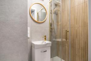 a bathroom with a sink and a mirror at miniSTUDIOS URSUS by VAYA STAYS in Warsaw +135 photos