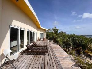 a wooden deck with benches and chairs on a house at Wonderful Winding Bay in Tarpum Bay