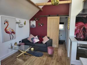 a living room with a couch and a glass table at Beautiful Self Contained Cottages in Westbury in Westbury