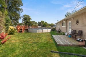 a backyard with a deck and a house at Poolside Palisade - A Fun Family Retreat for 6 in Marquette Heights