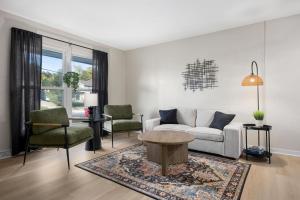 a living room with a couch and chairs and a table at Hines Haven - Unit 2 - Perfect BNB for YOU in Peoria