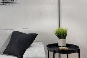 a table with a plant on it next to a couch at Hines Haven - Unit 2 - Perfect BNB for YOU in Peoria