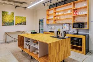 a kitchen with a wooden counter top in a room at Hello my friend in Bang Bua Thong Railway Station