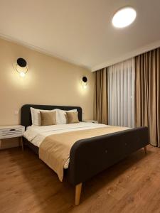 Ένα ή περισσότερα κρεβάτια σε δωμάτιο στο Bentley Apartments