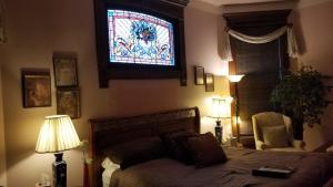 a bedroom with a bed and a stained glass window at Old Northside Bed & Breakfast in Indianapolis