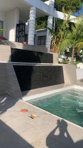 a swimming pool in front of a house at Knysna Nature's View in Knysna