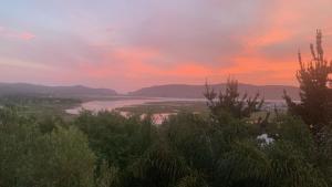 a view of a body of water at sunset at Knysna Nature's View in Knysna