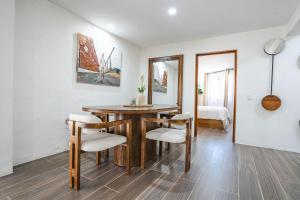 a dining room with a wooden table and chairs at Charming Bungalow Cajititlan 2 Beds Pool in Cajititlán