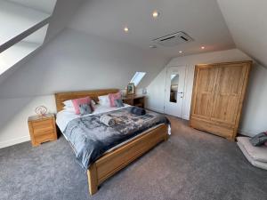 - une chambre avec un grand lit et un cadre en bois dans l'établissement Camelot House 1 Bed Duplex Sea View Cabrio Balcony, à Tintagel 22 autres photos