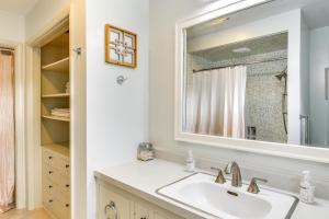 a bathroom with a sink and a mirror at Walk to Downtown - Home with Porch in Clayton! in Clayton +17 photos