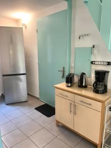 a kitchen with a refrigerator and a counter with pots and pans at Maisonnette les oliviers in Argelès-sur-Mer