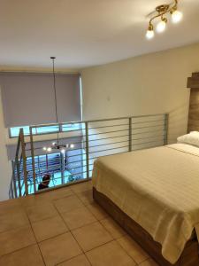 a bedroom with a large bed and a balcony at Mono en Duplex Velez Sarsfield 2 in Buenos Aires