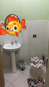 a bathroom with a fish head above a sink at Trindade encantada in Bombinhas