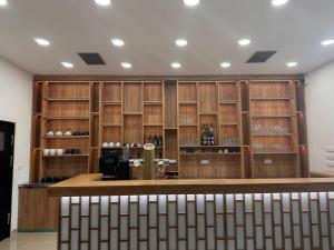 a bar in a room with wooden walls and shelves at Golden Hotel in Vyšší Brod +28 photos
