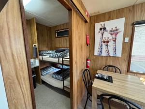 a room with two bunk beds and a table at Acacia Caravan Park & Holiday Units in Ararat +80 photos