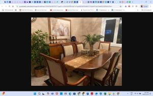 a dining room with a wooden table and chairs at Room # 3 Sleep 4 Arrangement in Edmonton