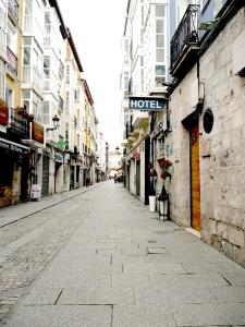 an empty street in a city with buildings at San Juan Centro Histórico in Burgos