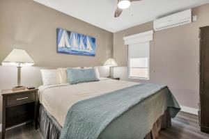 a bedroom with a large bed with a blue blanket at ULTRA magical apartment at the Beach in Hollywood