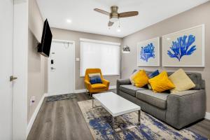 a living room with a couch and a tv at ULTRA magical apartment at the Beach in Hollywood